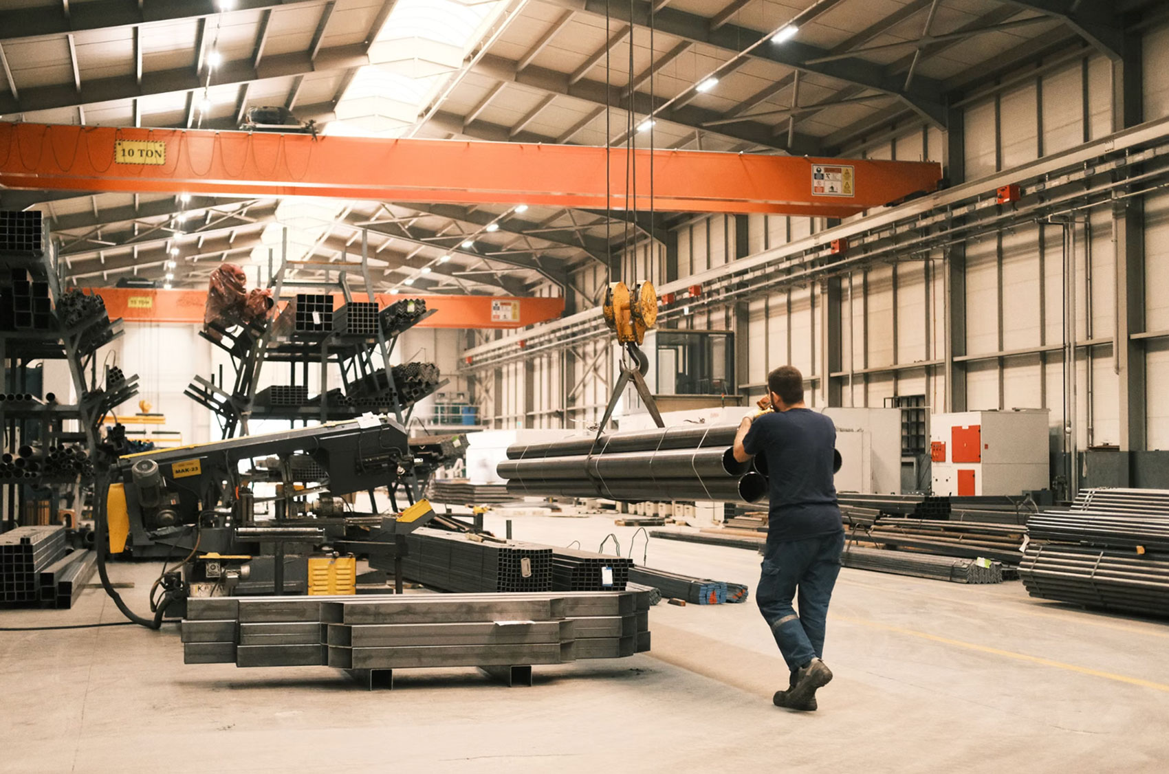 Fabrication warehouse with an overhead crane moving structural steel