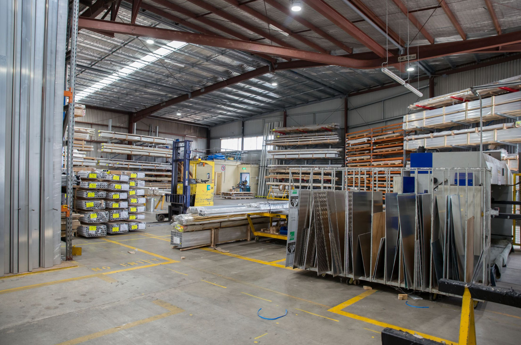 Racked steel and metal stock in an industrial warehouse