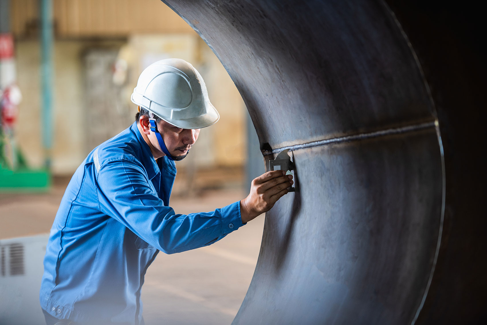 Engineer inspecting a fabricated steel weld